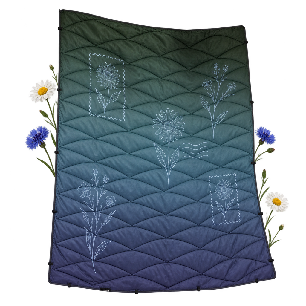 Nomadix CPB Puffer Blanket, a blanket draped over a bed, chair or sofa